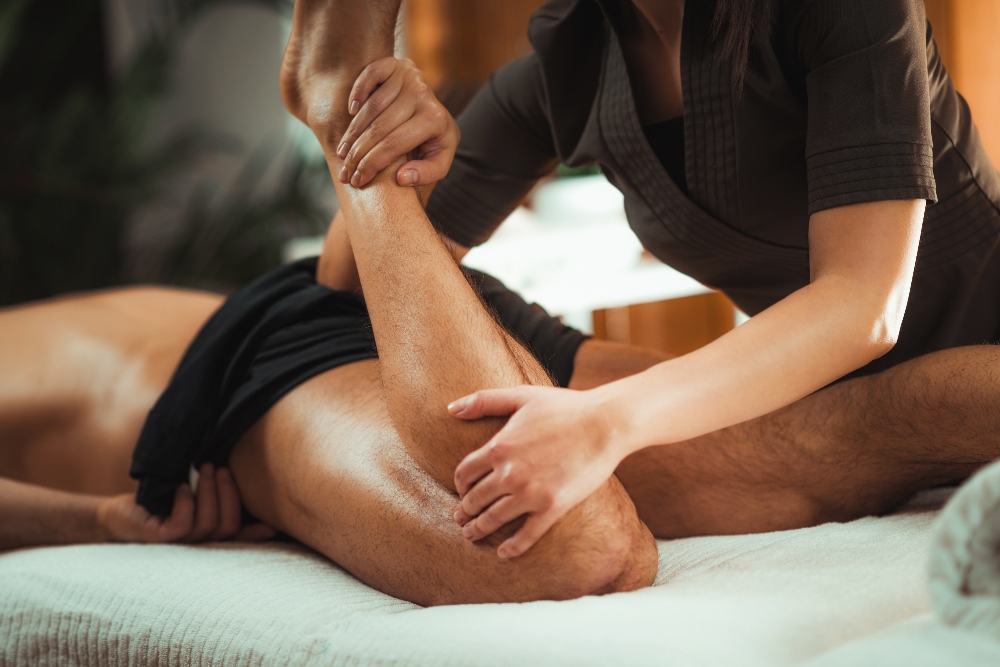 Therapist performing a deep tissue massage to aid muscle recovery